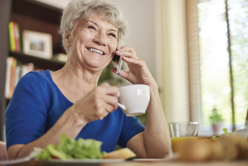 older woman smiling on the phone