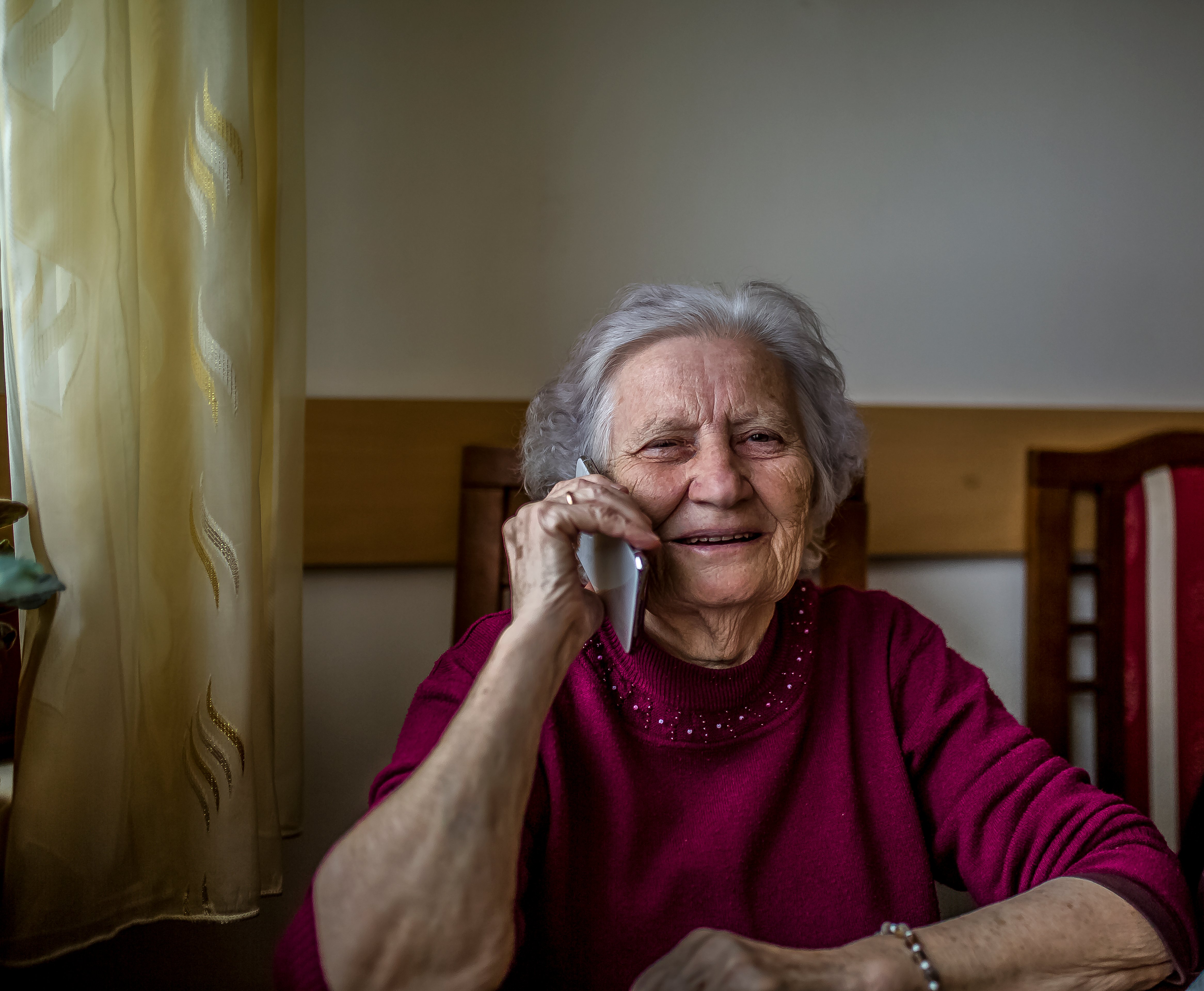 older woman smiling on the phone
